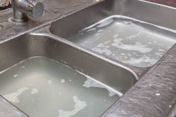 old sink clogged with dirty water